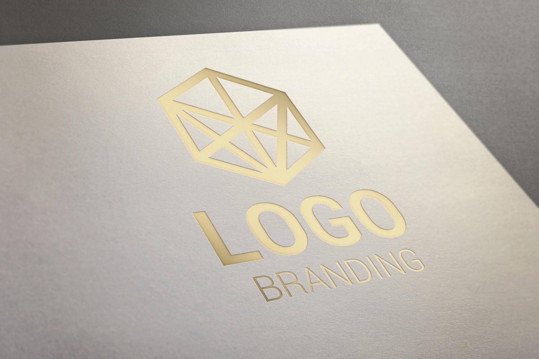 Gold logo presentation on white paper. Concept of company, visual identity, branding promotion